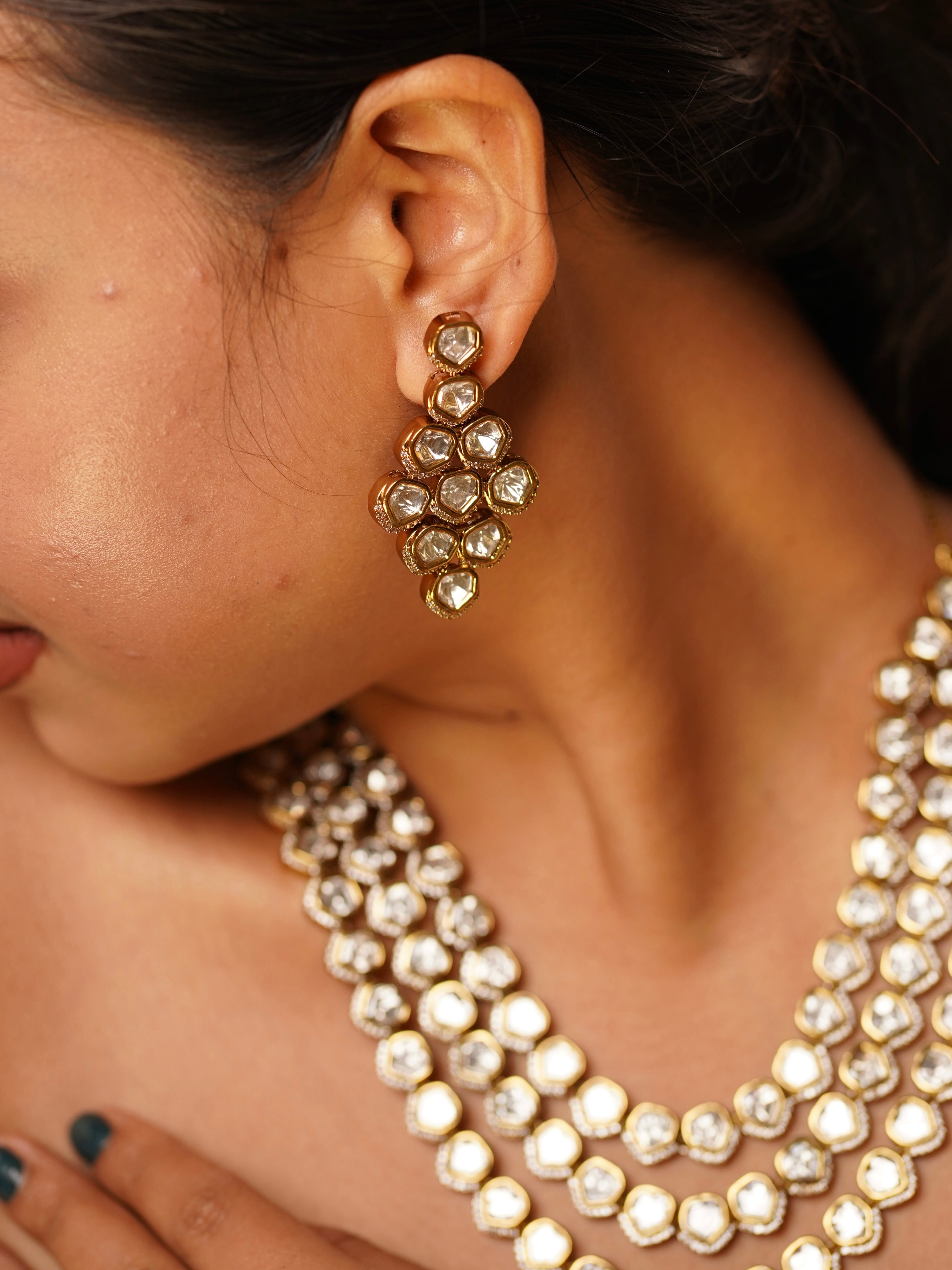 Close-up of central pendant in three-layer kundan necklace featuring reflective stones